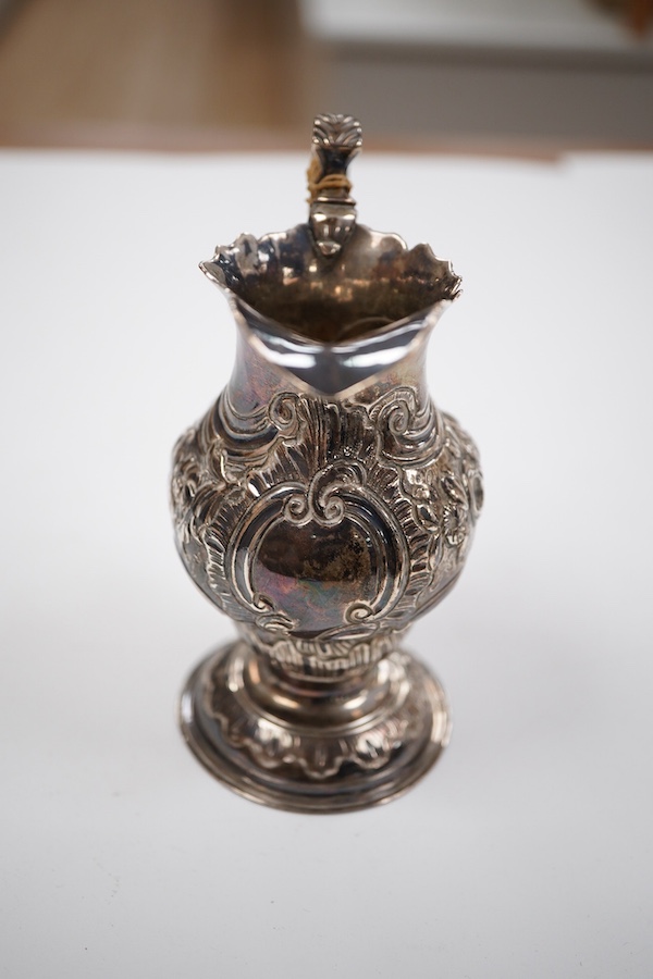 A George III silver inverted pyriform cream jug, with later embossed decoration, Charles Chesterman II, London, 1779?, height 11.4cm.